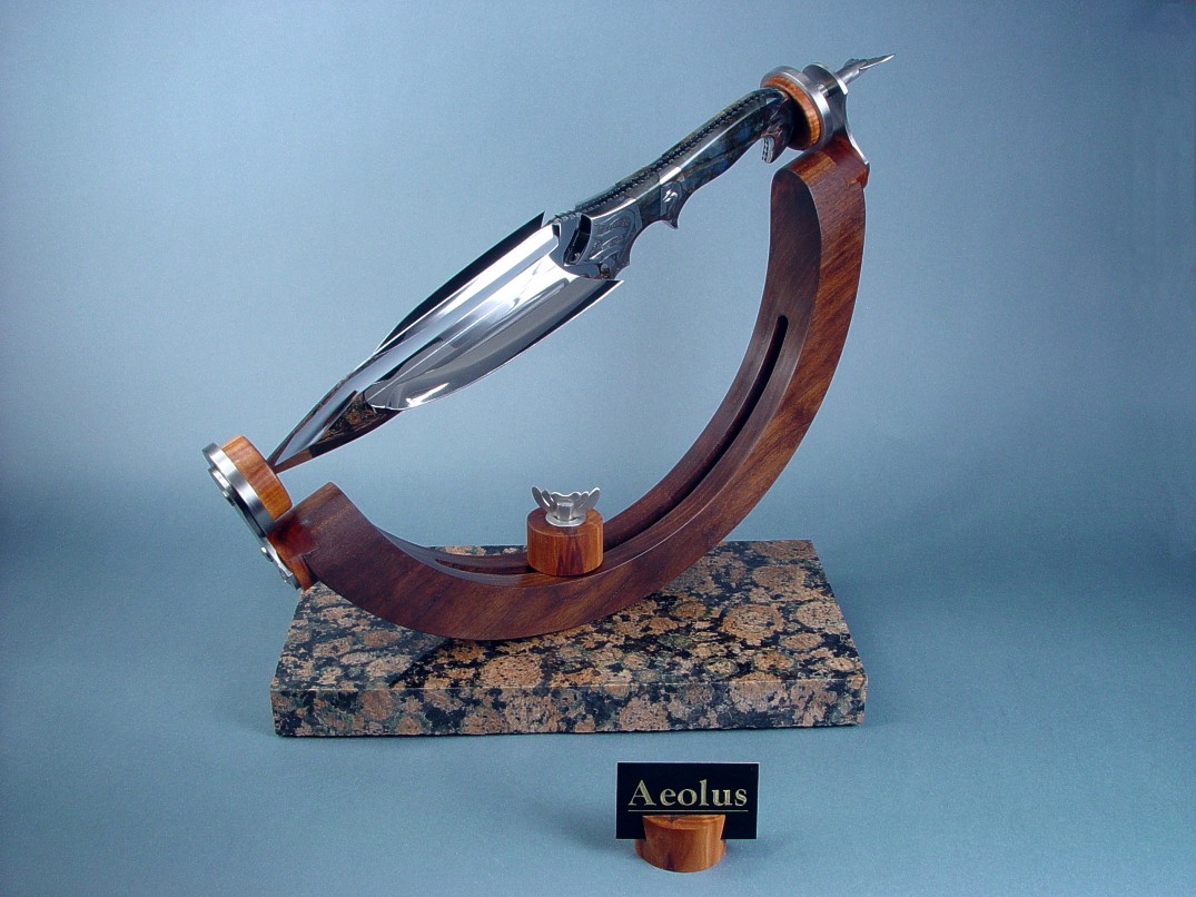 "Aeolus" in 440C high chromium stainless steel cross-blade, hand-engraved 304 stainless steel bolsters, Labradorite gemstone handle, stand of peach, American black walnut, 304 stainless steel, Baltic brown granite, engraved brass