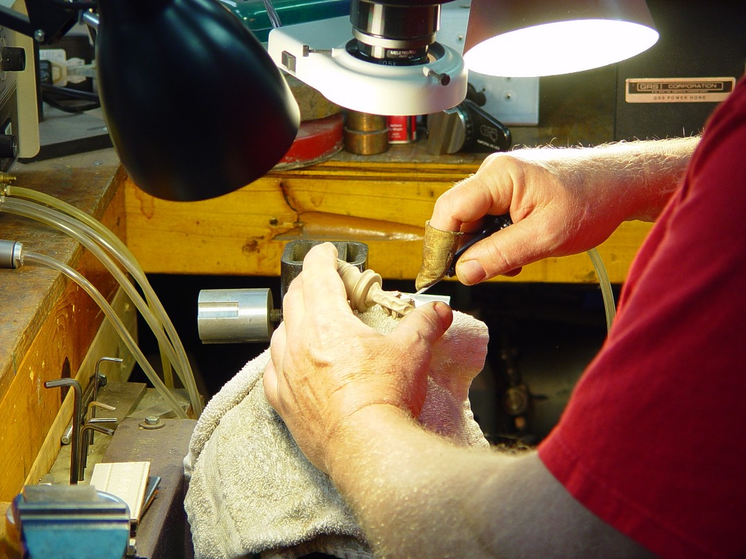 Hand-engraving cast bronze pommel made in-house