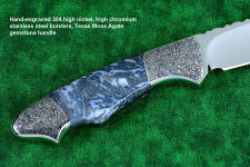 "Thuban" custom knife, obverse side view in CPM154CM powder metal technology, T3 cryogenically treated stainless steel blade, hand-engraved 304 stainless steel bolsters, Moss Agate gemstone handle, hand-carved leather sheath inlaid with frog skin